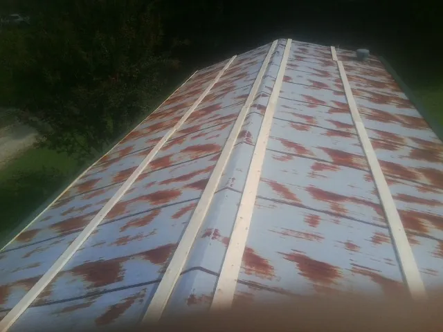 Rusted metal roof panels with new wood purlins before replacement — Storm Damage Roof Repair in Harmans by Roofing Brothers
